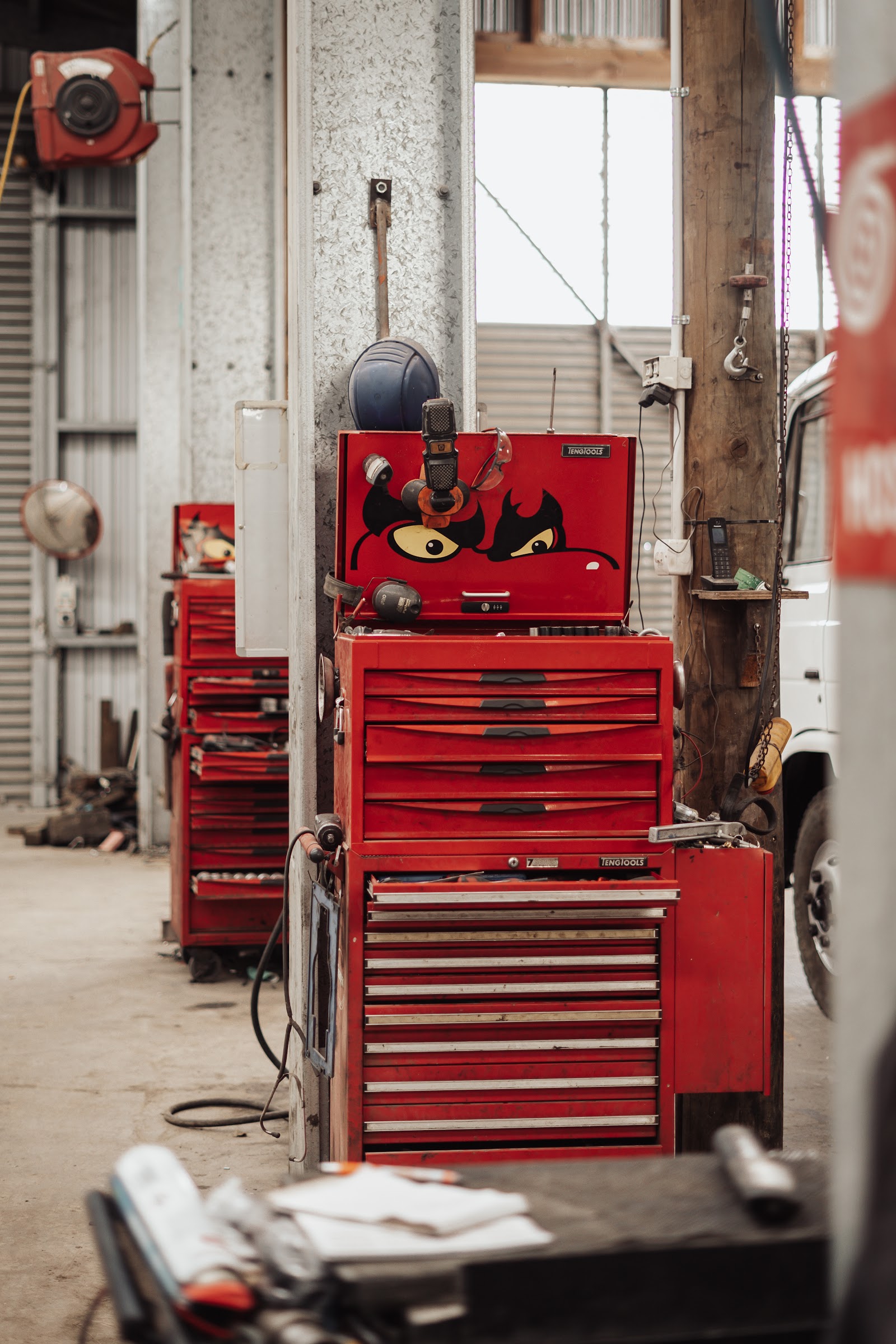 Red tool chests beside the inspection pit