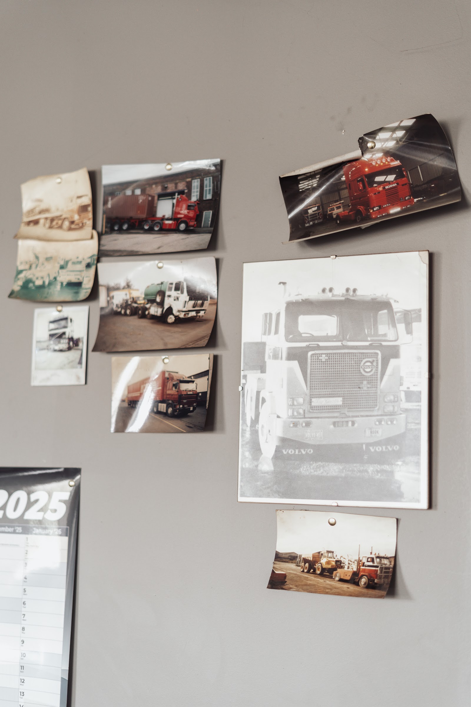 Faded photographs of the Holmes family's trucks in England